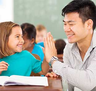 Man hi-fiving a young female student
